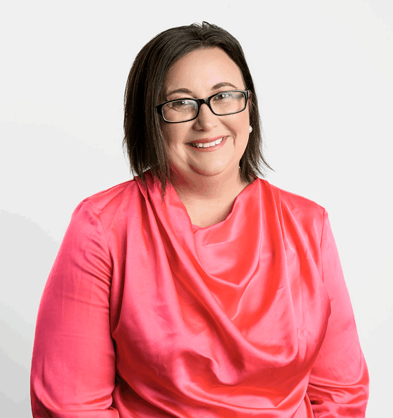 Portrait of Debbie Halteen, Front Office Coordinator, wearing glasses and pink uniform