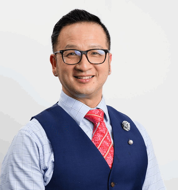 Portrait of Dr. Gregory Chang, Principal Dentist, smiling in uniform