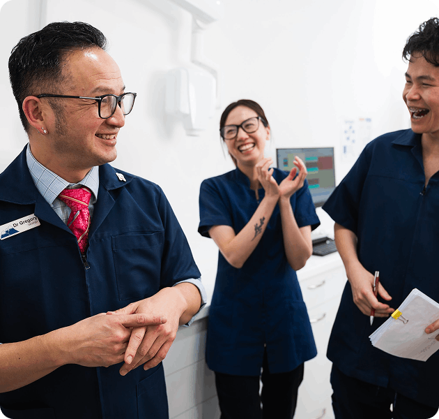 Hepburn Heights Dental team standing and smiling with dental tools