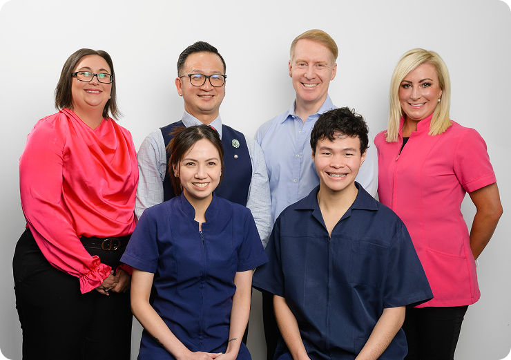 Group photo of the Hepburn Heights Dental Centre team smiling in uniform